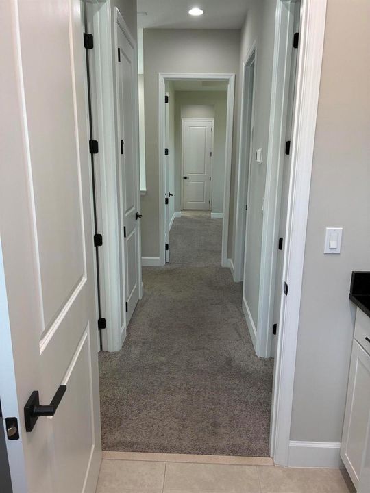 Hallway to upstairs rooms from laundry r