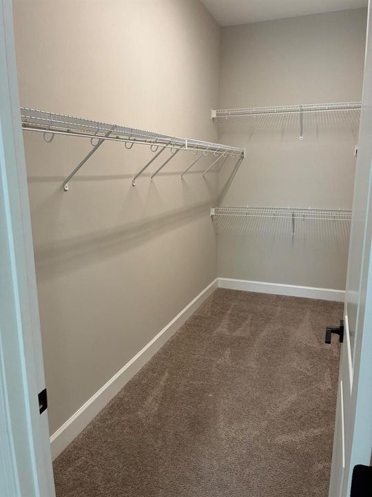 Master closet with shelving on both side