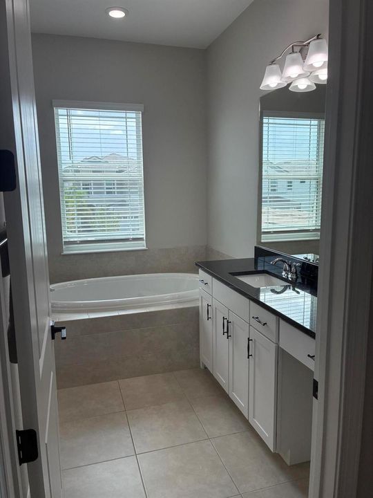 Master bathroom with vanity area and dee