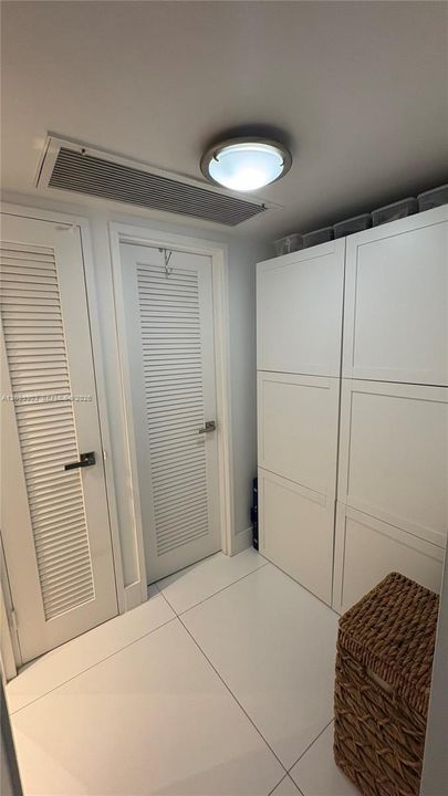 Primary walk-in closet, linen closet, along with a separate area used for more closet space, office nook, etc