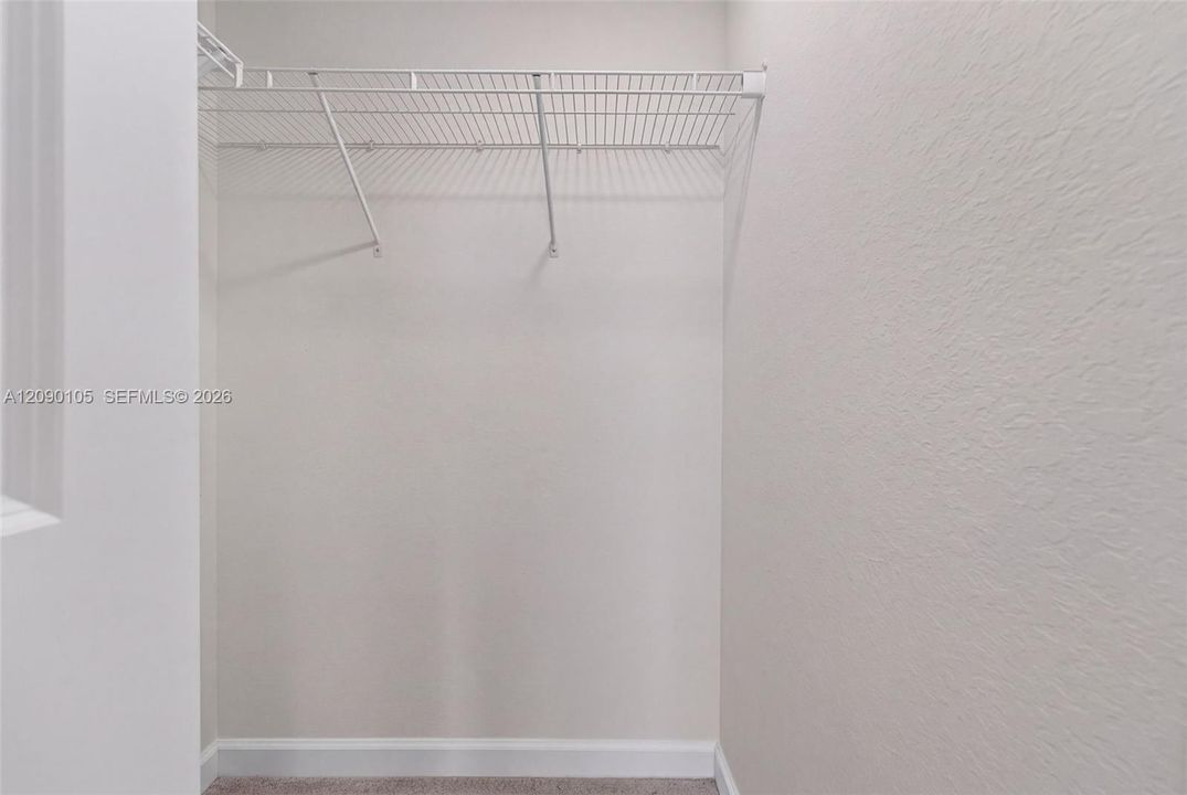 Walk-in closet featuring neutral wall finishes and white wire shelving