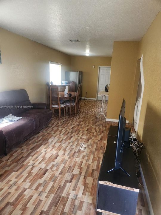 Multipurpose interior space featuring patterned tile flooring and a single-panel interior door