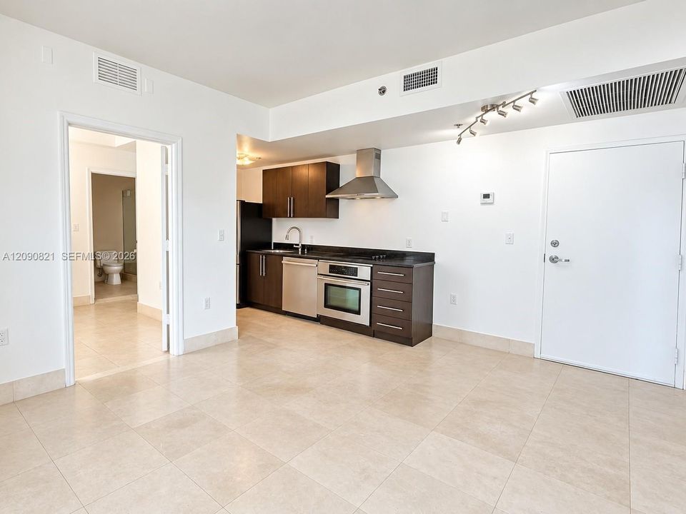 Bright and spacious open living area with clean tile flooring throughout.