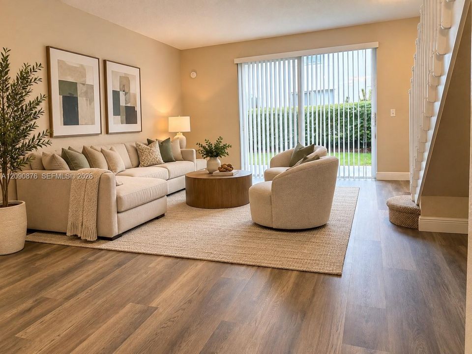 Wood-finish flooring throughout, sliding glass door with vertical blinds, and a carpeted staircase with white railings
