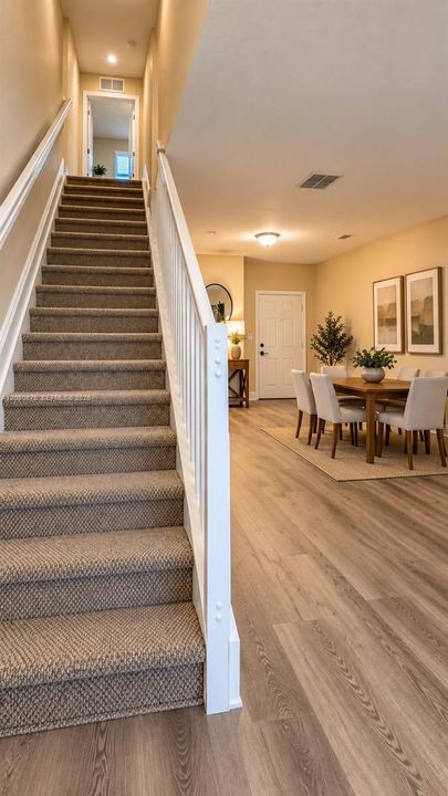 Stairway with carpeted treads and white wood railings