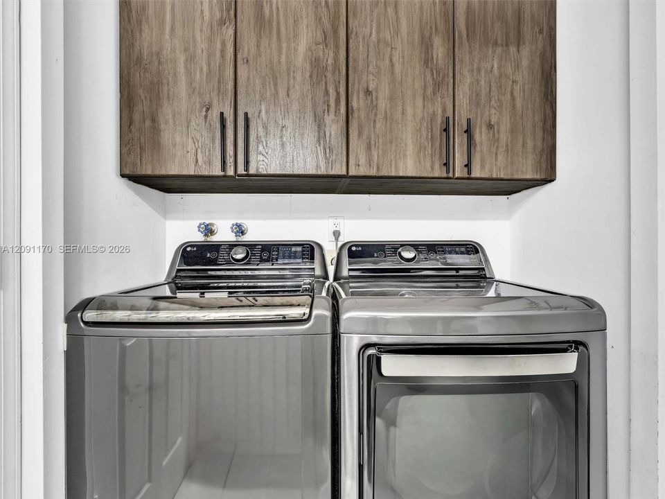 Washer and dryer inside the third bathroom.