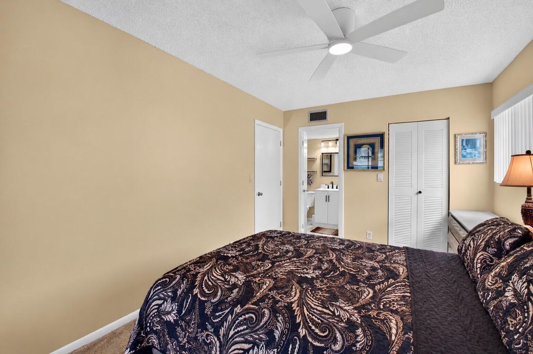 Tidy Bedroom with Open Bathroom Door