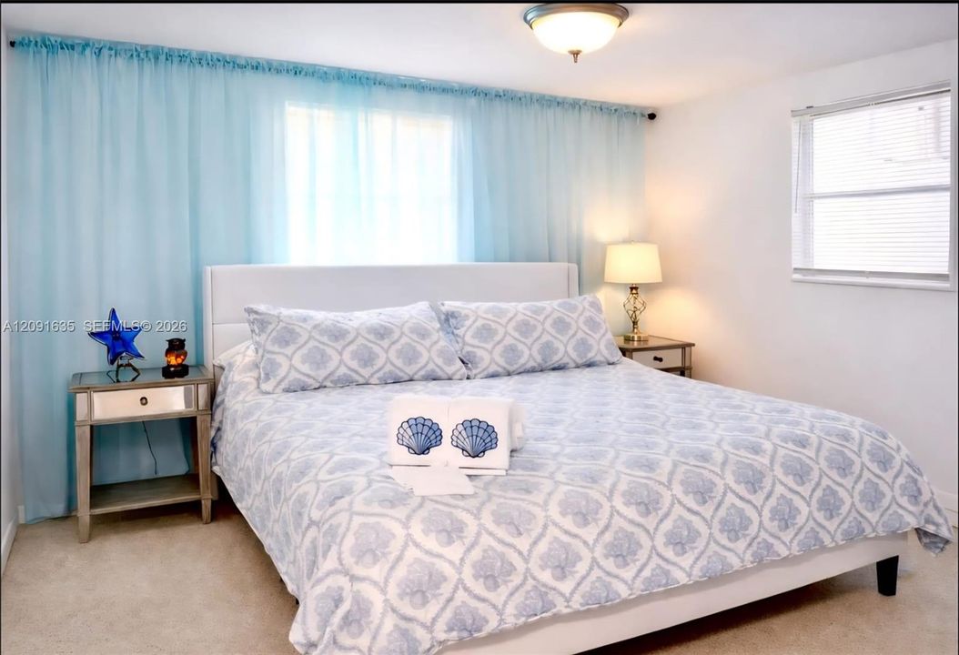 Inviting guest bedroom filled with natural light, modern finishes, and neutral decor.