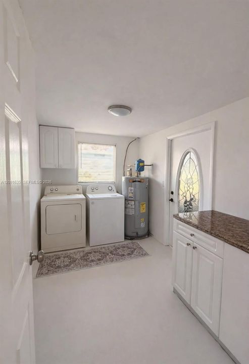 Dedicated indoor laundry room with modern washer/dryer hookups and extra convenience.