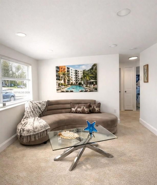 Spacious and bright living area with recessed lighting, designed for comfortable everyday living and entertaining.