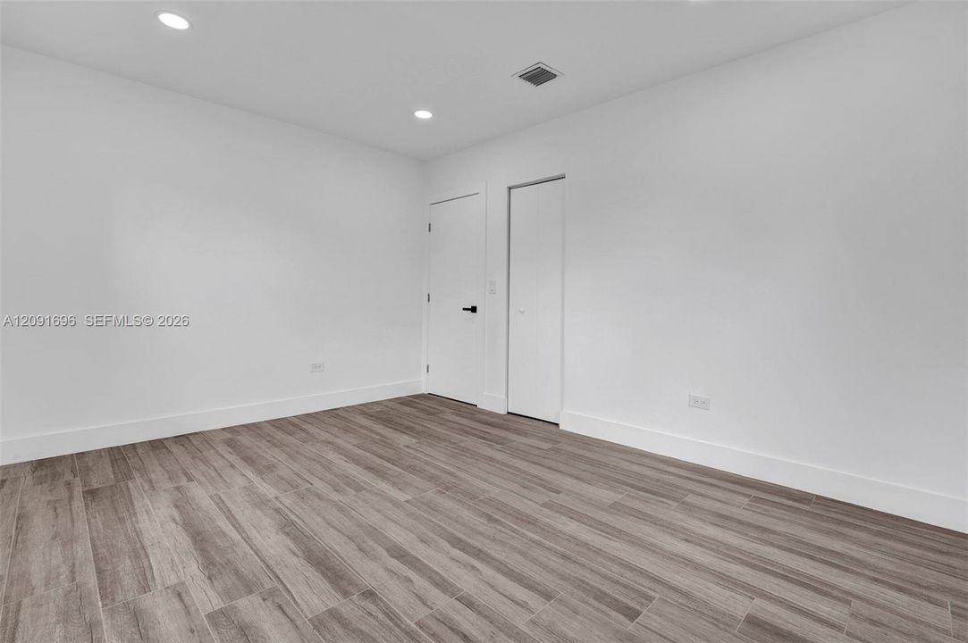 Interior space featuring wood-finish flooring, recessed lighting, and a closet with a bi-fold door