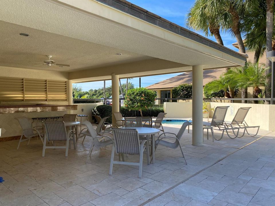 Covered seating area by pool oak
