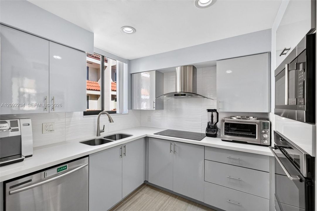 Sleek Gloss Gray Cabinetry Befits this Elegant Townhouse