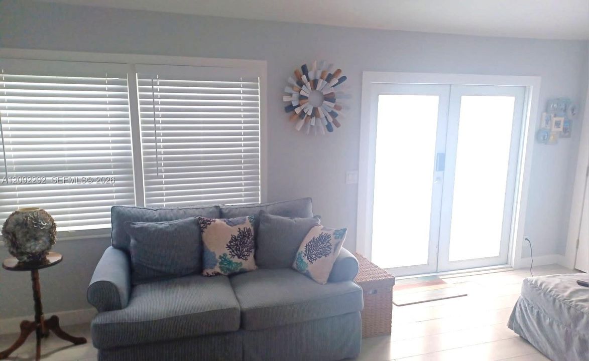 LIVING ROOM WITH IMPACT FRONT DOOR