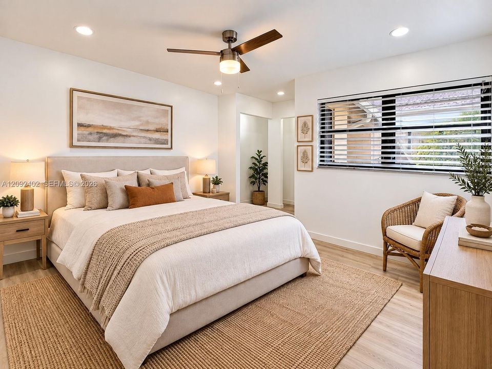 TV console & plants virtually staged for illustrative purposes.  Neutral-toned interior featuring wood-finish flooring, recessed lighting, and a modern ceiling fan with an integrated light fixture