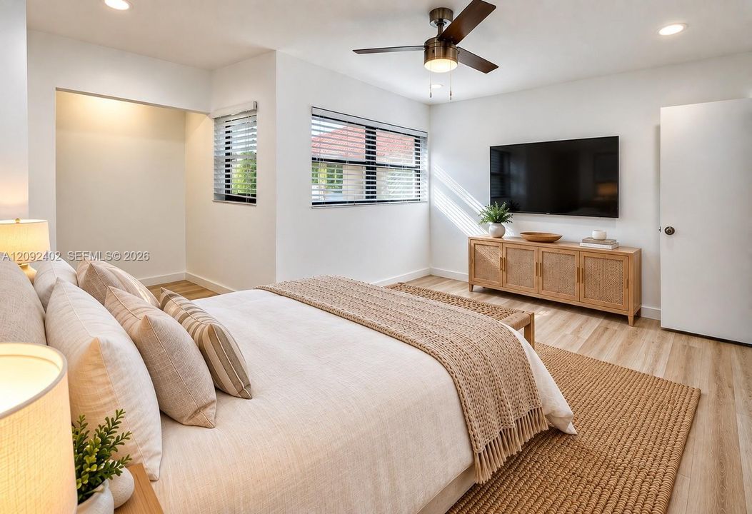 TV console & plants virtually staged for illustrative purposes.  Interior space featuring wood-finish flooring, recessed lighting, and a ceiling fan with integrated light fixture