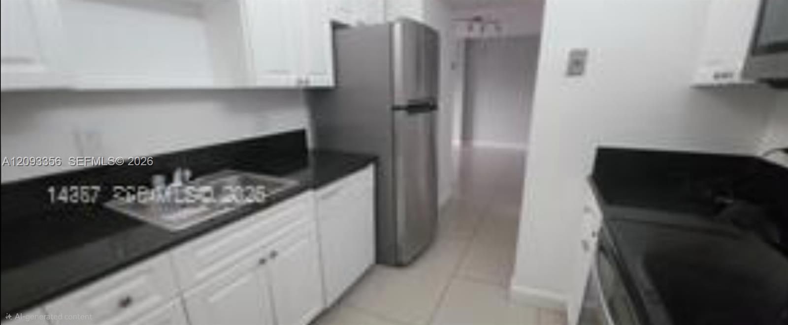 Kitchen featuring white shaker-style cabinetry, Quartz stone countertops, stainless steel refrigerator, and tile flooring