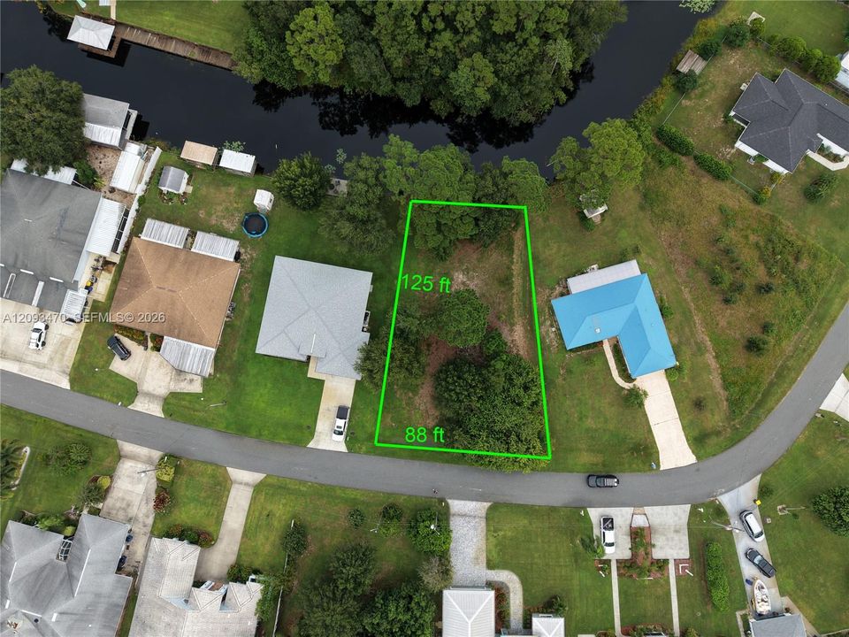 Waterfront lot featuring mature trees, a 125-foot depth, and an 88-foot street frontage