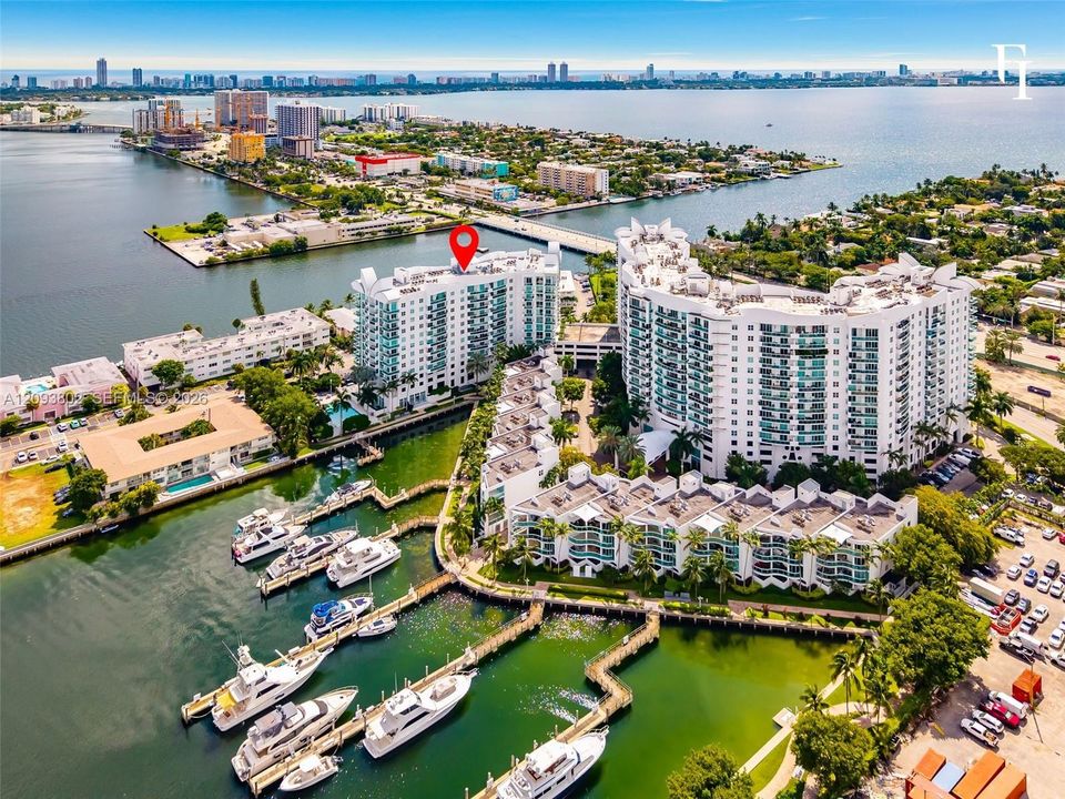 Waterfront high-rise building featuring private deep-water boat slips, expansive exterior balconies, and direct proximity to open coastal waters
