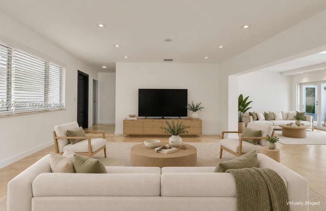 Neutral interior featuring recessed lighting, herringbone wood-finish flooring, horizontal window blinds, and glass-paned double doors