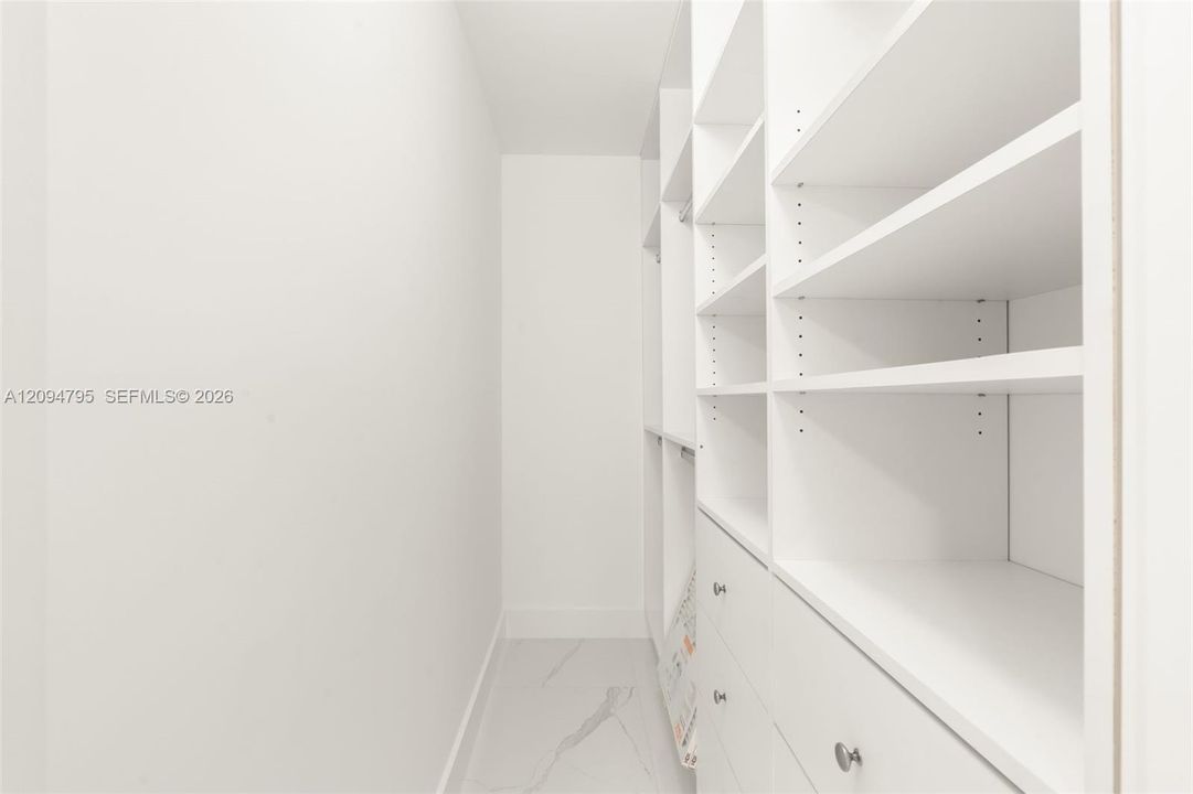 Secondary Bedroom walk in closet with built in storage