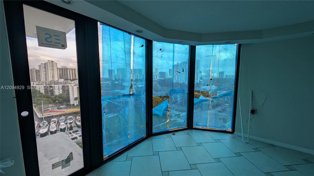 Floor-to-ceiling windows featuring black framing and tiled flooring