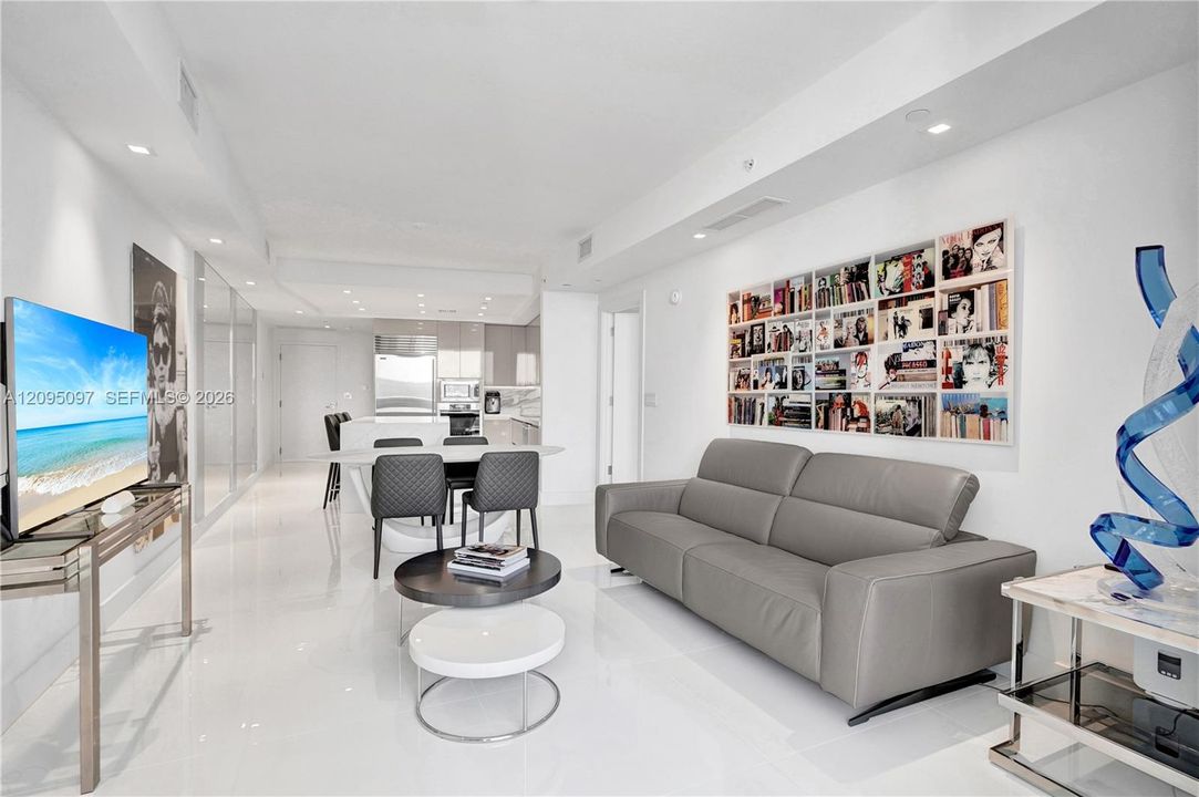 Polished tile flooring, recessed ceiling lighting, and sleek modern cabinetry