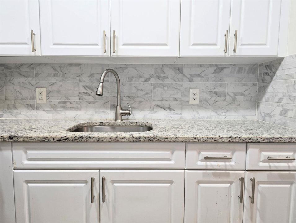 White cabinets with Stone backsplash