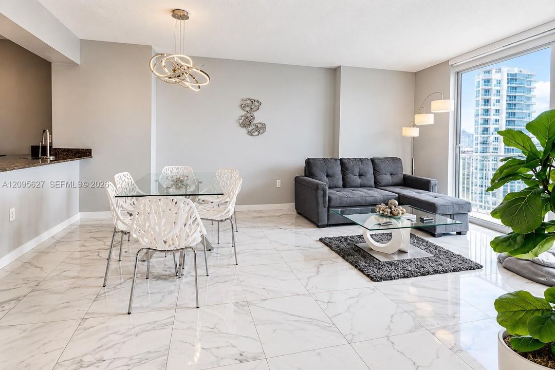 Spacious living and dining area with white marble-look floors