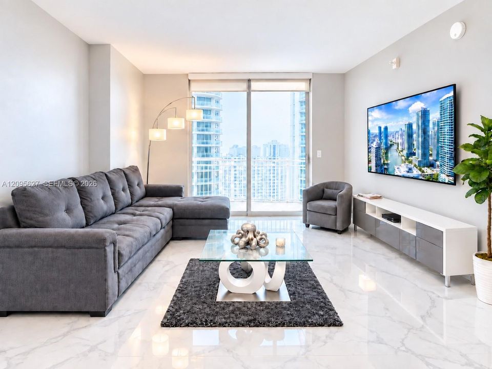 Living room with floor-to-ceiling windows and access to balcony