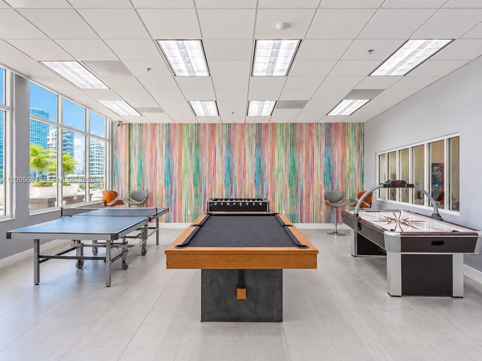 Game room featuring ping pong, billiards, and air hockey tables.