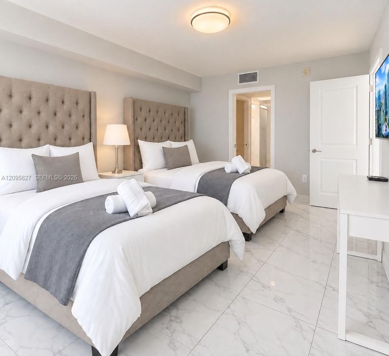 Bright bedroom with two queen-size beds