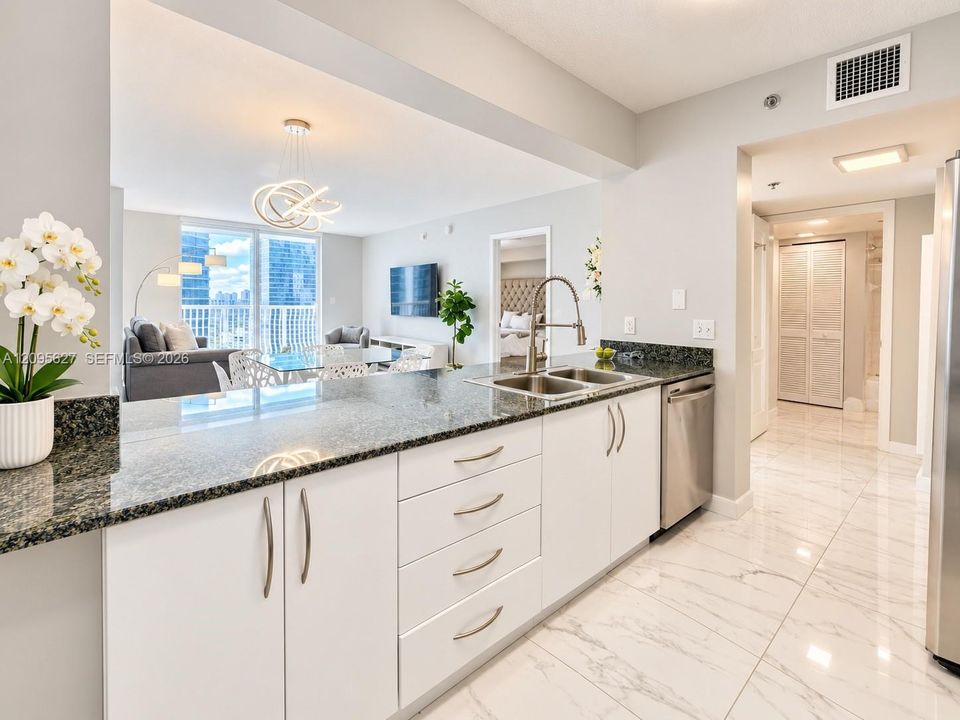 Kitchen with white cabinetry and breakfast countertop