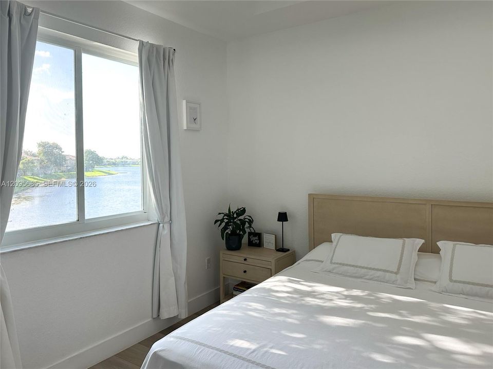 Primary bedroom with lake views.
