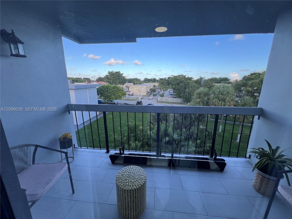 Covered balcony featuring large-format tile flooring, metal railing, and recessed ceiling lighting