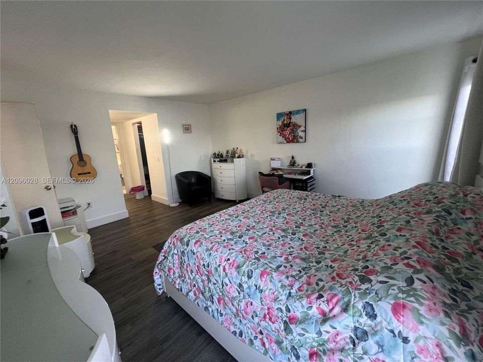 Interior room featuring wood-finish flooring and neutral wall paint