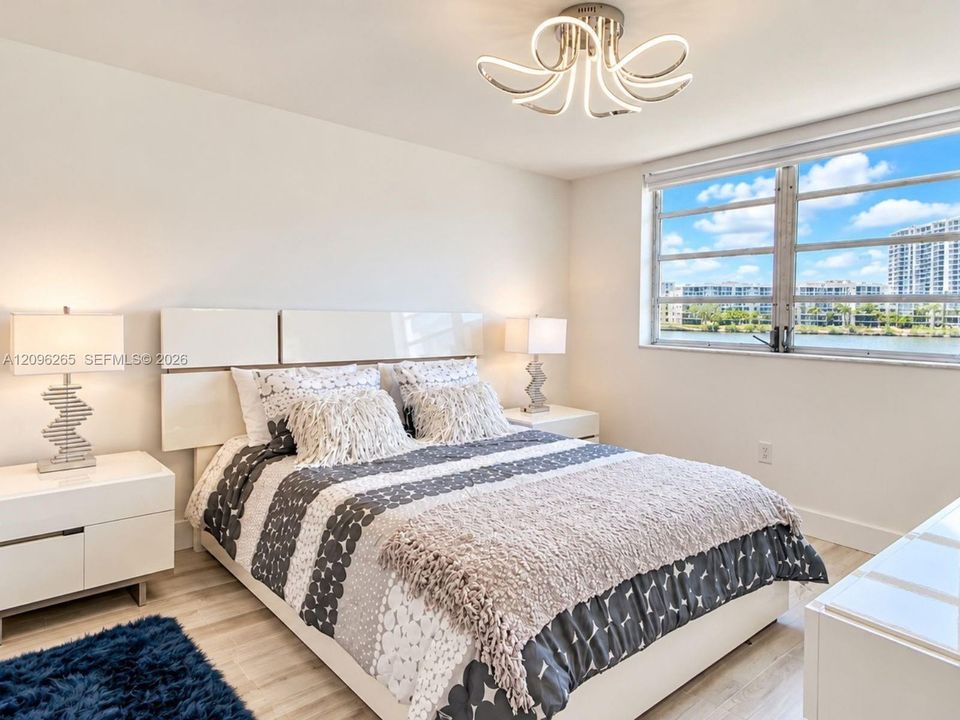 Spacious primary bedroom featuring ample natural light, generous closet space, and comfortable furnishings.