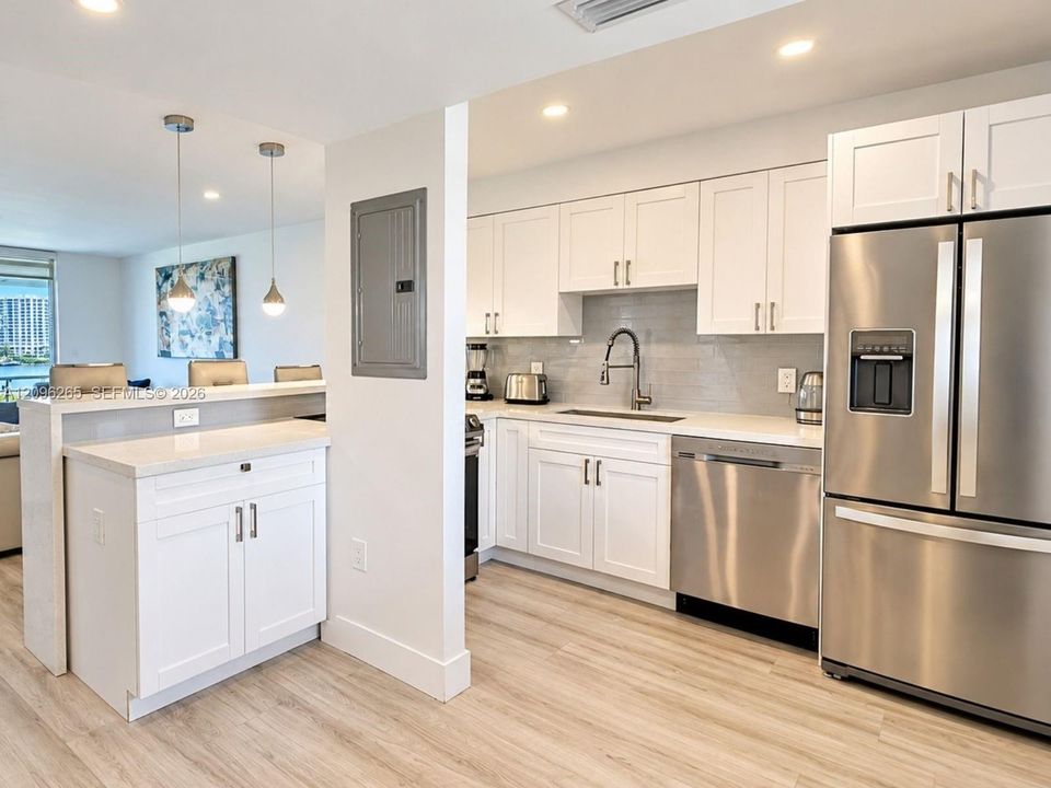 Sleek updated kitchen with modern cabinetry, stainless steel appliances, and ample counter space.