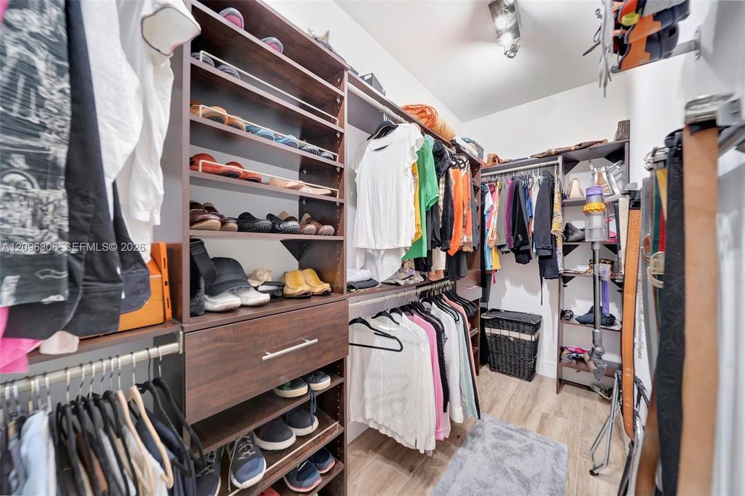 Primary bedroom walk-in closet with custom installation