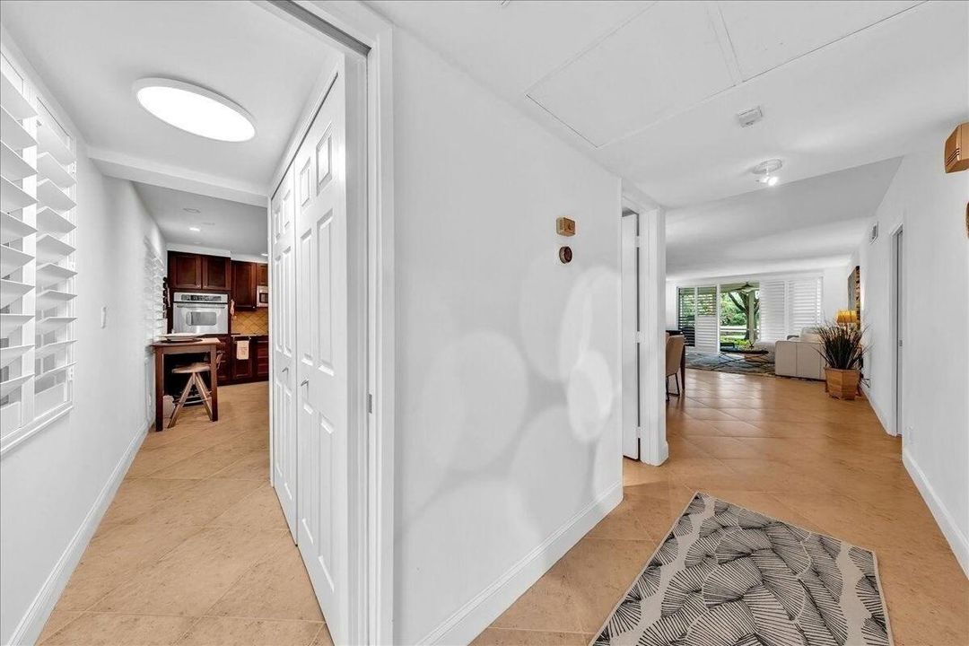 View of laundry closet, foyer, and liv