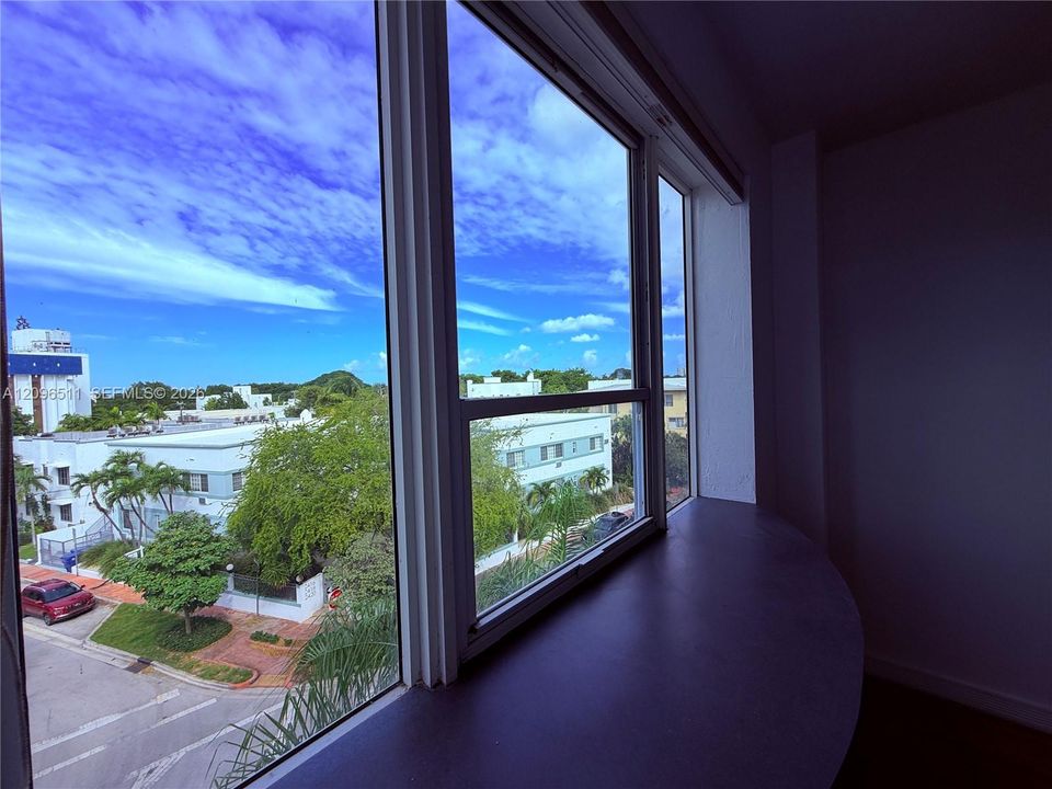 Expansive multi-pane window featuring a wide, rounded built-in sill