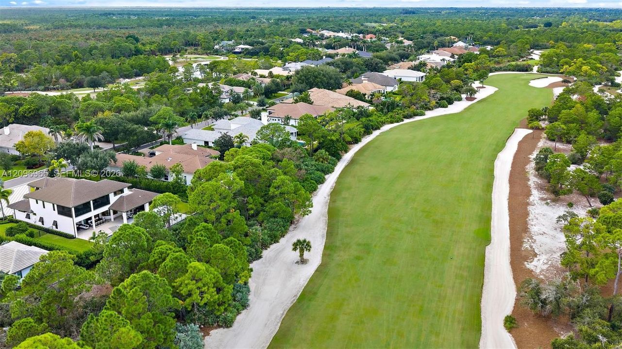 Aerial perspective featuring direct frontage on a manicured golf course, mature perimeter landscaping, and expansive green space