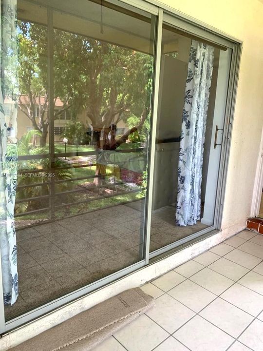 BEDROOM SLIDERS TO SCREENED TILED PATIO WATER VIEW