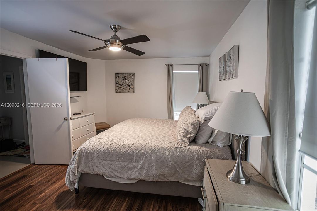 A calm, light filled retreat with a ceiling fan.
