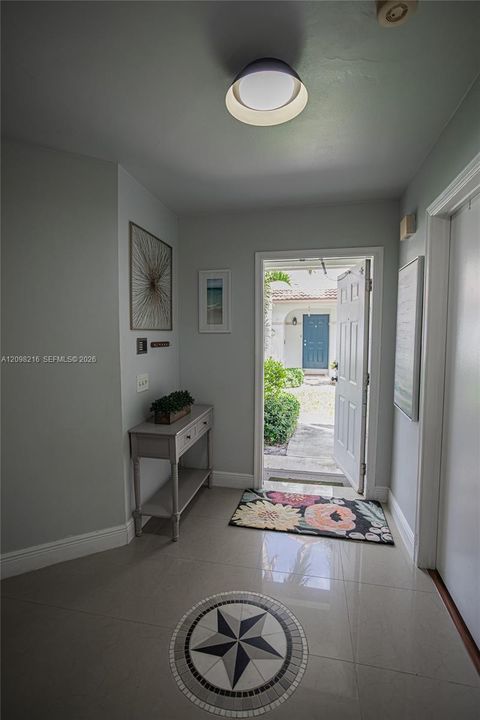 Bright entry hall with tile floors and natural light leading into the main living space.