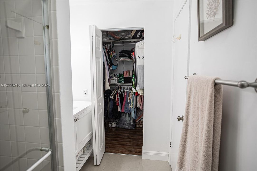 Bathroom with direct access to a walk-in closet.
