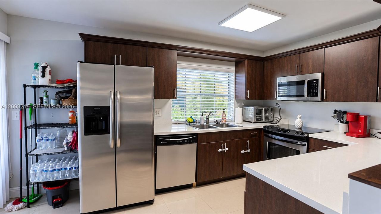 Bright kitchen with a window over the sink and plenty of counter and cabinet space.