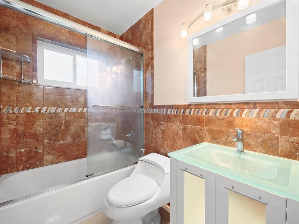 Full bathroom with a clean, functional layout and tiled finishes.