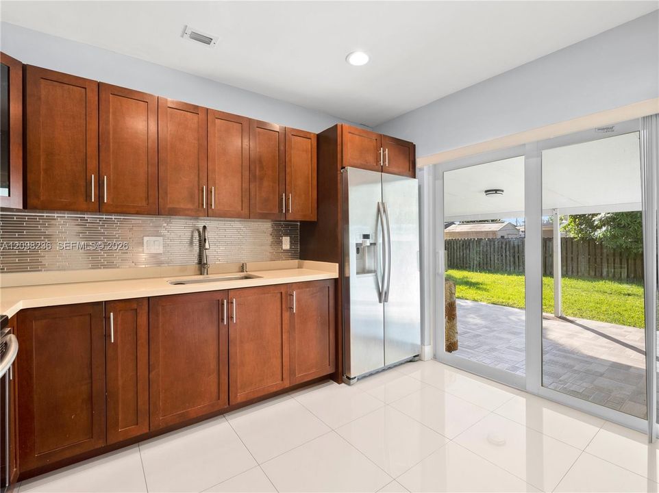 Bright kitchen with direct access to the covered patio and private backyard.