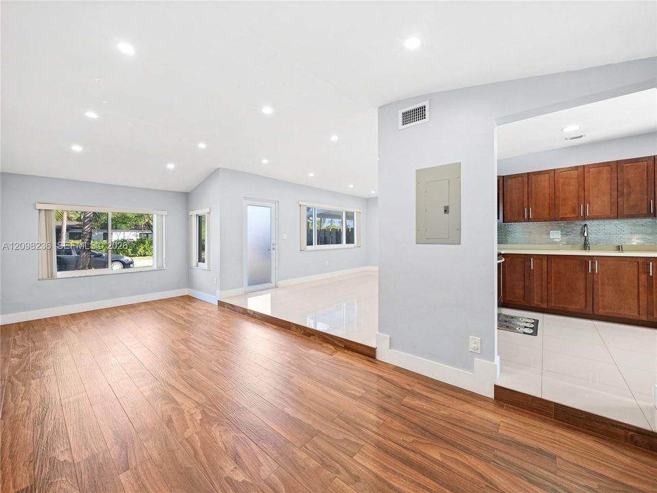 Spacious dining area with wood-look flooring and an open connection to the updated kitchen.